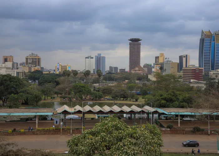 Nairobi cityscape featuring modern skyscrapers and lush greenery on a cloudy day.
