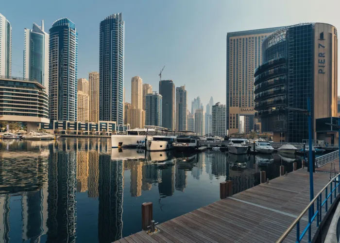 Explore the breathtaking skyline of Dubai Marina with iconic skyscrapers and luxury yachts.